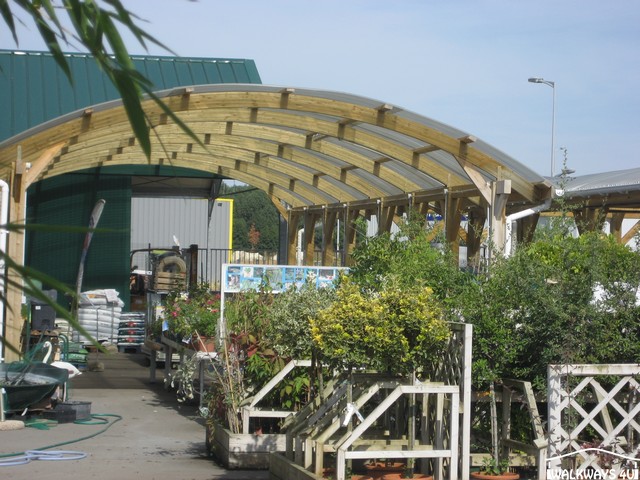 Walkway Canopies, pathway covers, wooden constructions,  entrance canopy, timber shelters, laminated curved room beams, commercial buildings covered areas glazed