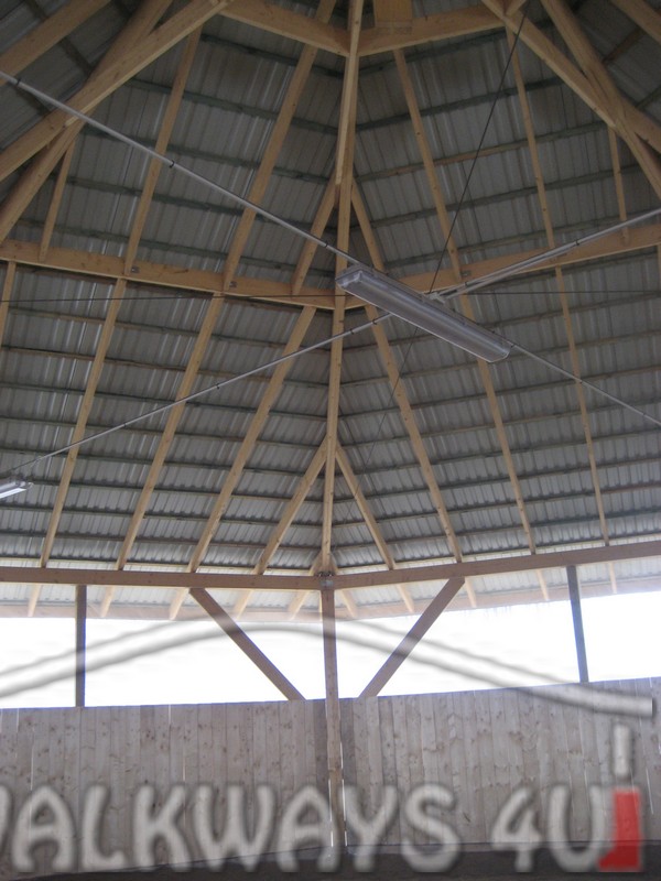 Photo 03. Fully covered lunge pen for lungeing or working horses. The fully covered roof is constructed with laminated wood